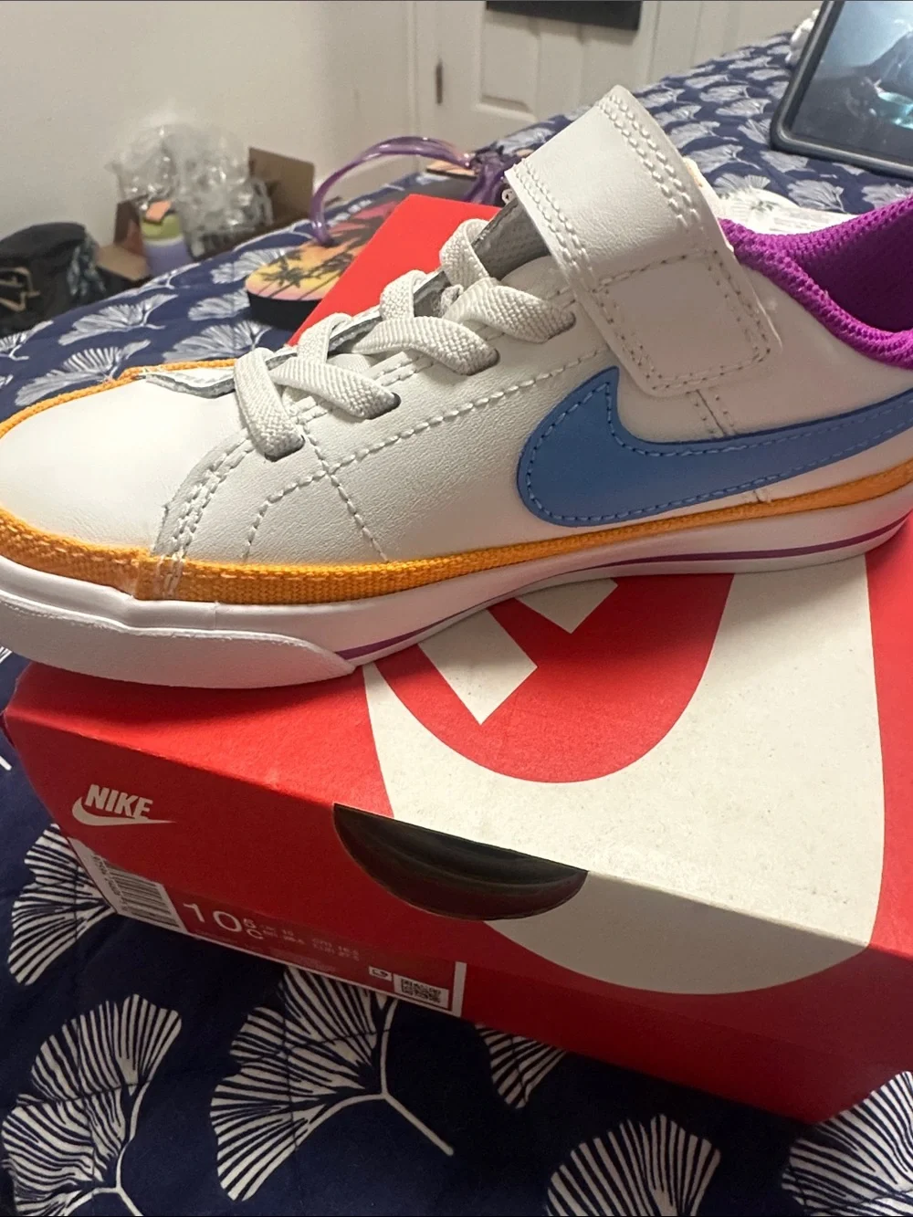 Nike Kids White Sneaker with Blue Swoosh and Purple Lining